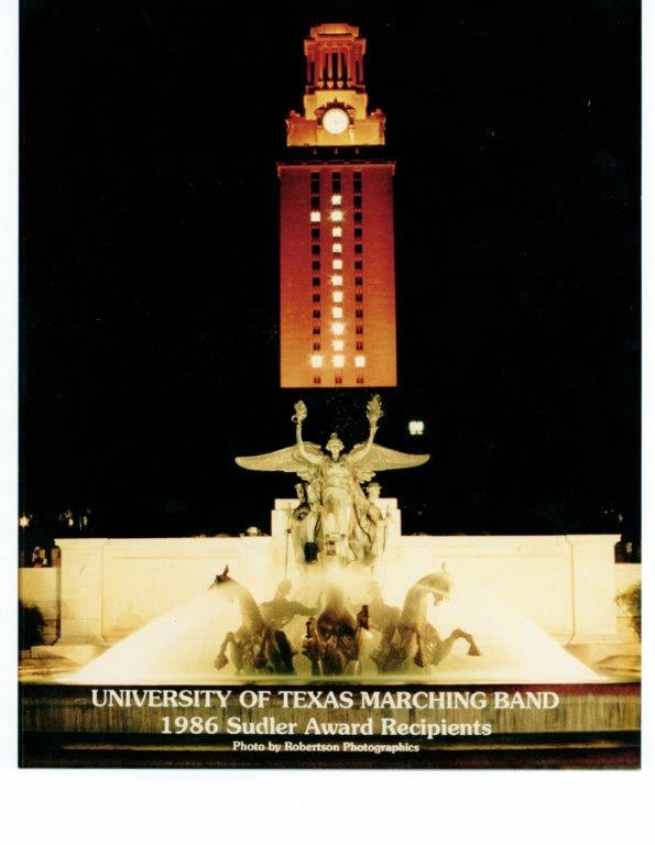 The UT Tower lit orange with the number 1 in the windows honoring the Longhorn Band